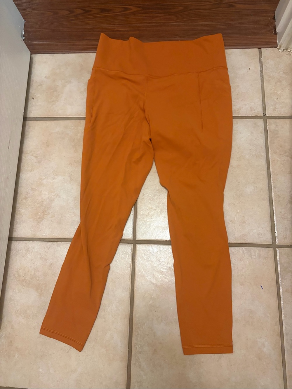 womens burnt orange Athleta salutation stash pocket II tight